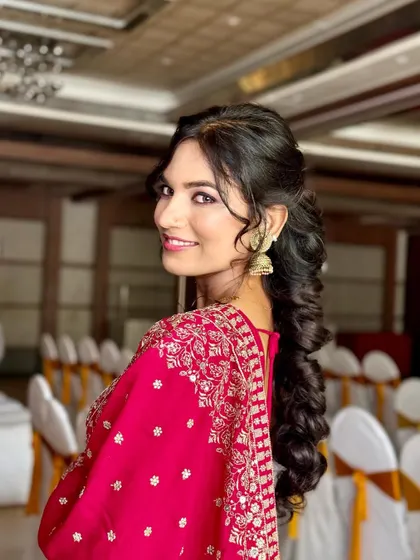 A beautiful smile to complete the look. This client is glowing in her party-ready lehenga, with makeup that enhances her features and a hairstyle that adds glamour.
