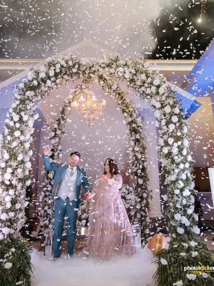 The couple waves to their guests amidst a shower of confetti, a joyous and celebratory moment from their engagement party.