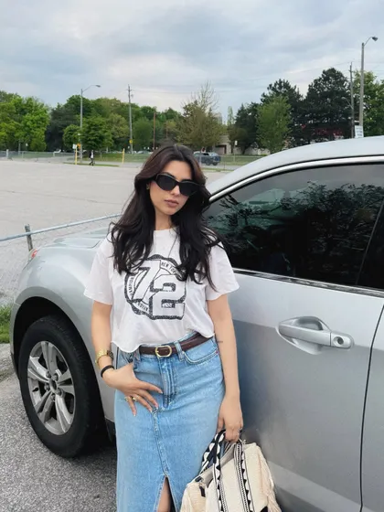 A full-body shot of my trendy long denim skirt and graphic tee outfit.