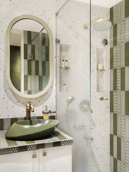 The Olive Lavatory, where olive green patterned tiles, terrazzo, and brass accents create a symphony of design.