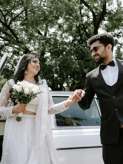 A happy Christian couple making their grand exit, with the groom helping his bride out of the car. It's these small, chivalrous moments that tell a big story.