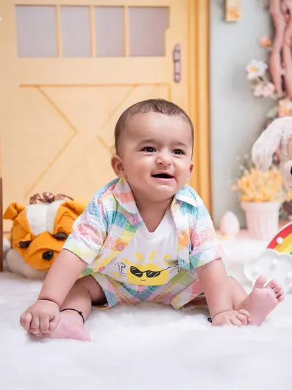 This happy baby's smile lights up the studio. We capture these genuine moments of joy as they explore our safe and comfortable space during their sitter session.