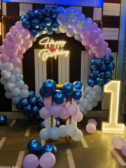 A first birthday ring decoration in shades of blue and pink with a light-up number '1'.