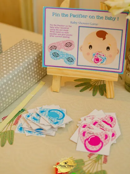 A fun and simple game for all ages: 'Pin the Pacifier on the Baby'. I set up this station with custom-printed game boards and pacifier cutouts, making it an easy and interactive part of the celebration.
