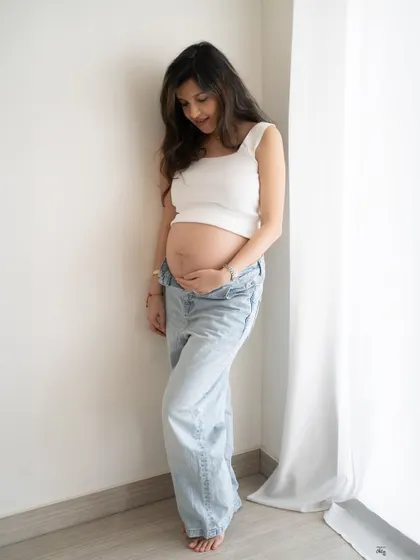 A quiet, downward glance at her growing bump. This simple, minimalist photo in natural light is full of love and anticipation.