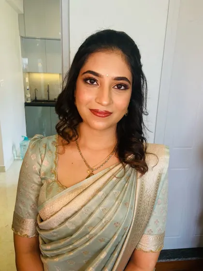 The final result for Mahima's home ceremony. A soft, glowy makeup look with gentle curls that feels elegant and effortless.