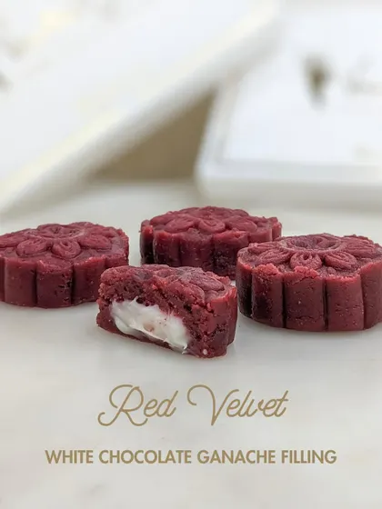 The Red Velvet Xmas Cake Mithai, featuring a classic red velvet flavor and a sweet white chocolate ganache filling.