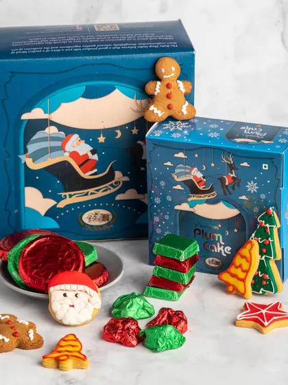 The Jingle Bell Feast Hamper is a Christmas explosion in a box. It's packed with our round plum cake, assorted cookies, chocolate chikkis, chocolate biscuits, and assorted chocolate rocks for a complete festive experience.
