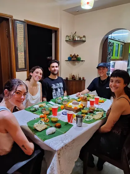 A full table of happy guests from around the world, ready to enjoy the feast they helped prepare. This is what my home dining experience is all about: community, culture, and delicious food.