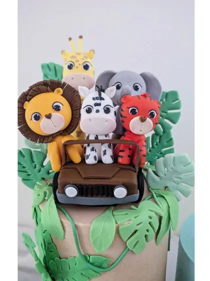 A close-up of the jungle safari cake, with adorable fondant animals peeking out of a jeep.