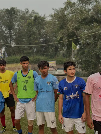 Players listening intently during a training session. Discipline and focus are core values we teach at our academy.