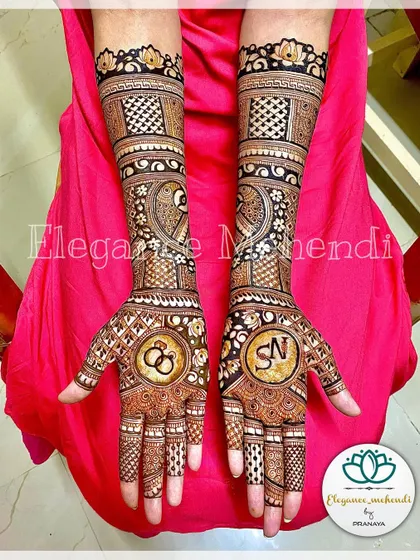 A full view of the customized engagement mehendi, showing how the initials and ring symbols are integrated into a complete and beautiful design.