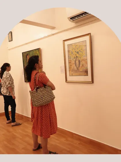 Two visitors in conversation while viewing a still-life painting. We aim to create a space that sparks dialogue.