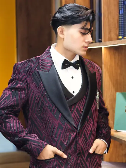 For a client who wants to make an entrance, I designed this custom three piece tuxedo. The deep purple fabric with its unique geometric pattern and black satin lapels is for the man who isn't afraid of bold style.