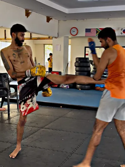 A student lands a low kick during sparring. We drill how to both throw and defend these crucial strikes.