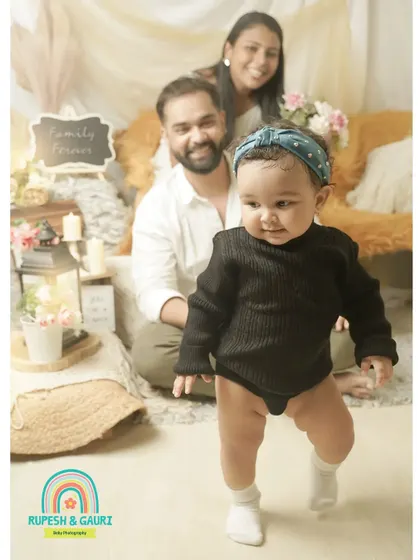 A baby's first steps are a huge milestone. We captured this little one on the move while mom and dad watch with pride in the background.
