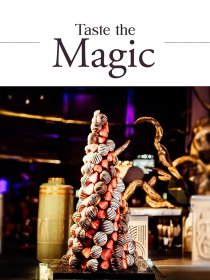 A magnificent strawberry and chocolate tower stands as a centerpiece. This is an example of how we can create show-stopping dessert features that become a talking point at any event.