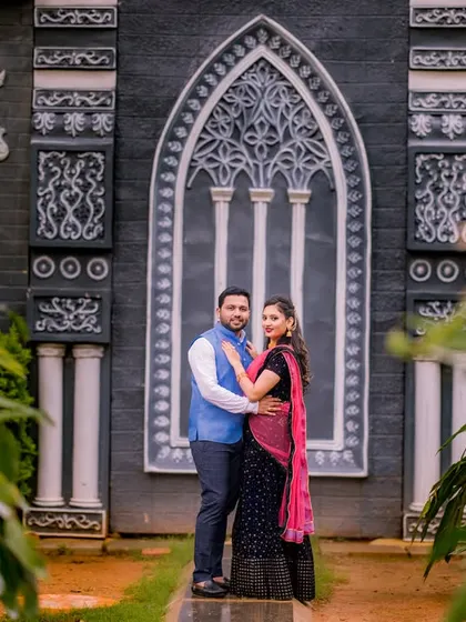 A lovely portrait in front of a gothic-style architectural feature. The couple's traditional attire looks beautiful against this unique and dramatic backdrop.