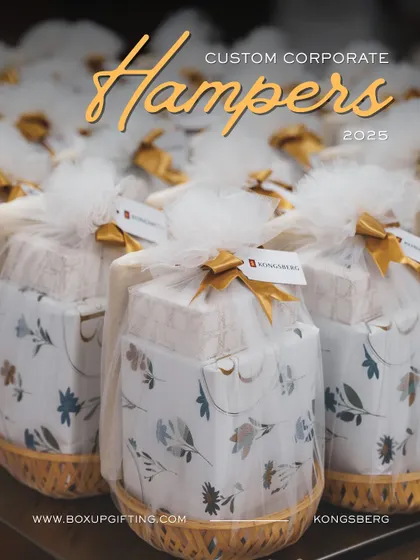 Custom hampers for Kongsberg, beautifully wrapped in wicker baskets and tulle. This is a great example of how we can create unique packaging solutions for your corporate gifting needs.