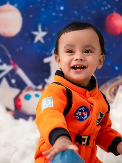 To the moon and back! My studio is equipped for imaginative adventures, like this astronaut theme. I provide all the props and costumes to bring your child's biggest dreams to life in a creative photoshoot.