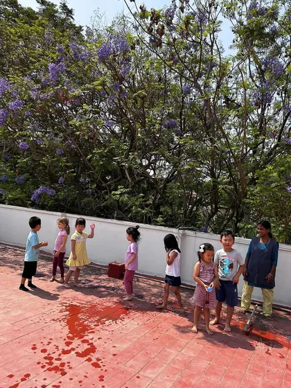 A water balloon splash on the terrace was a highlight of our water-conscious Holi fun.
