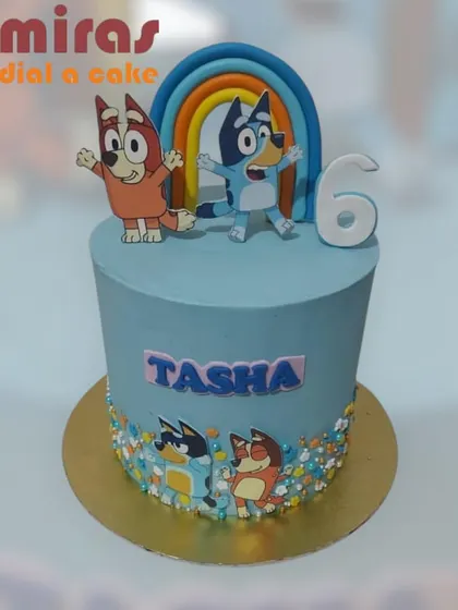 This simple and sweet Bluey cake features the beloved characters under a rainbow. It's a clean and modern design perfect for a fan's sixth birthday party.