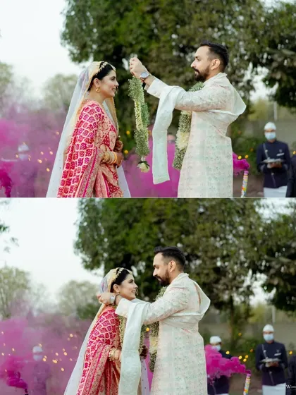 The Varmala ceremony captured with vibrant pink smoke in the background. This two-photo sequence shows the moment of exchange, a key ritual in Indian weddings.
