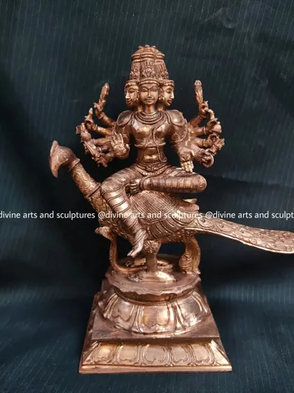 A 10-inch Panchaloha sculpture of Lord Murugan, the Tamil god of war, seated on his peacock. This compact yet detailed piece was created for a temple in Thailand.