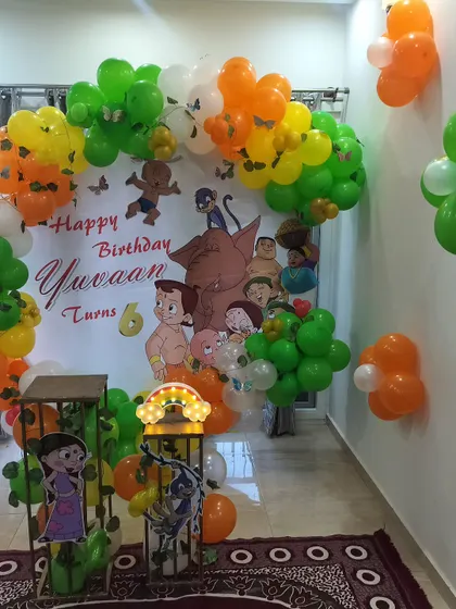 Celebrating a 6th birthday with India's favorite cartoon, Chota Bheem. This setup features a custom backdrop with all the characters from Dholakpur, framed by a colorful balloon ring in orange, green, and white.