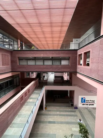 The central atrium of the Azim Premji University in Bhopal. The space is designed for natural ventilation, with connecting bridges and open corridors that allow air to move freely through the building.