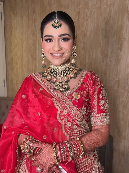 A classic bridal portrait. The makeup is perfectly balanced, with attention to the eyes, lips, and skin to create a look of pure elegance.