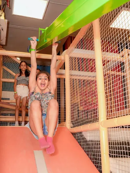 A guest having a blast as she glides down the zipline in our indoor play area.