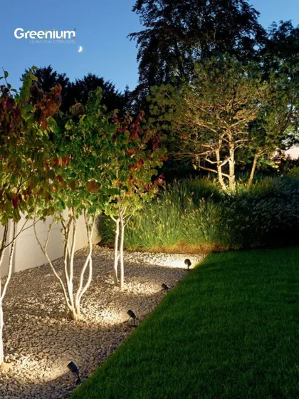 From concept to reality, I turn visions into breathtaking outdoor spaces. This image shows a beautifully lit garden path at night, highlighting how I use lighting to create ambiance.