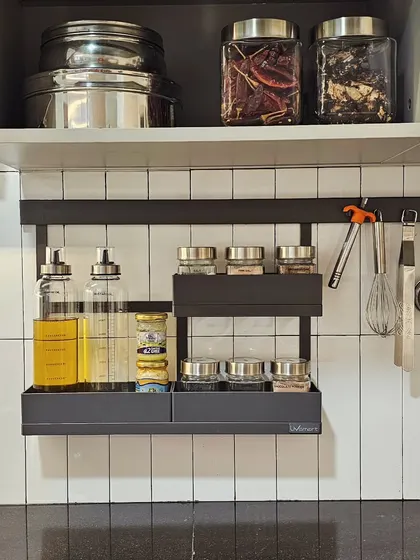 The backsplash is your kitchen's best friend. Using a wall-mounted rack for frequently used spices and oils keeps your counters free, giving you more space to cook and making cleanup much faster.