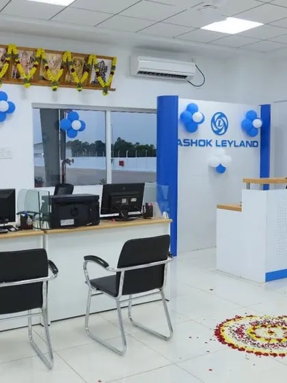The reception and customer service area at the Ashok Leyland facility. The layout is clean and professional, designed to handle customer interactions efficiently while reflecting the brand's corporate identity.