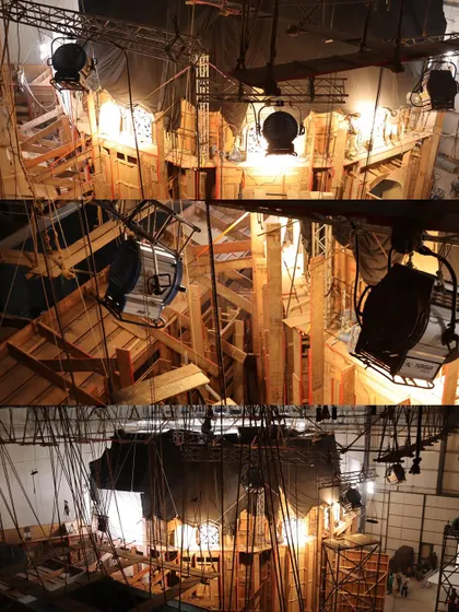 The back of the 'Chhaava' set, revealing the raw wooden structures and the lighting fixtures positioned to create the authentic, warm look of the period film.