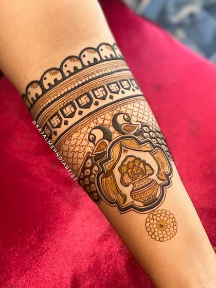 This arm band features mini elephants for good luck, a swastika for blessings, and peacocks with a kalash for prosperity. So many beautiful symbols in one design.