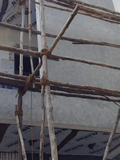 Another angle of the exterior preparation. You can see the protective sheets and scaffolding, which are part of my standard process for any exterior wall painting job in Bangalore.
