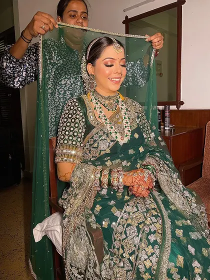 I love capturing these final moments. Here, I'm helping the bride with her dupatta over the traditional bun I styled for her wedding day.