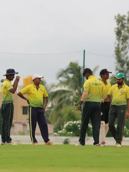 A team huddle during a break in play, discussing tactics. Our spacious ground allows for these moments of strategic planning.