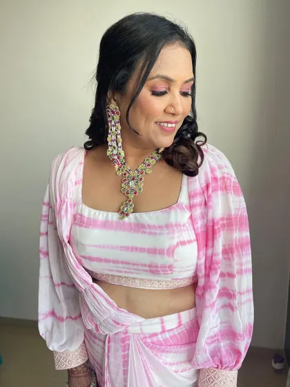 How much pink is too much pink? Never enough. The beautiful mother of the bride, looking stunning in a tie-dye outfit and matching pink makeup.