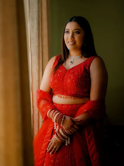 A beautiful portrait of the bride, Monika, in her stunning red reception lehenga.