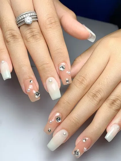 A beautiful and elegant set for a bride or any special occasion. We used a milky white ombré base and adorned it with a scattering of pearls and rhinestones.