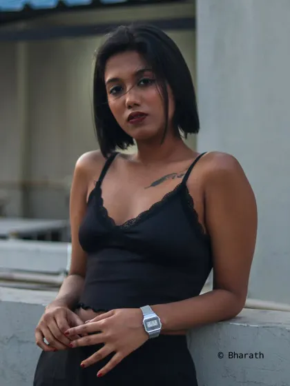 An urban portrait with the soft colors of the sunset sky in the background. The golden hour light is perfect for creating moody and stylish shots.
