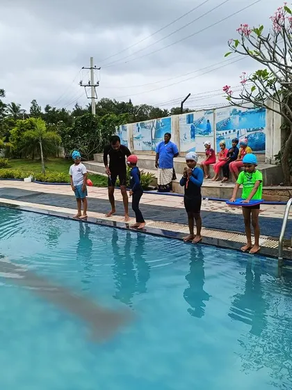 Young swimmers get instructions from their coach before a practice session. Our pool provides a safe and encouraging environment for learning.