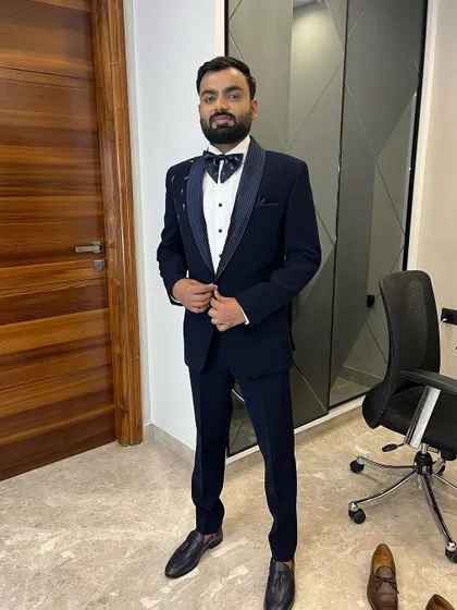 A full-length shot of a groom in a classic navy tuxedo. My service ensures the entire look is cohesive, from the polished shoes to the perfectly styled hair.