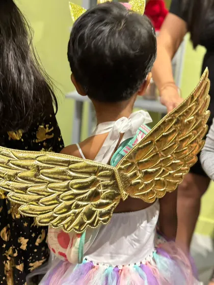 An angel in the house! The back of this beautiful costume shows off a pair of golden wings, adding a touch of magic to the party.