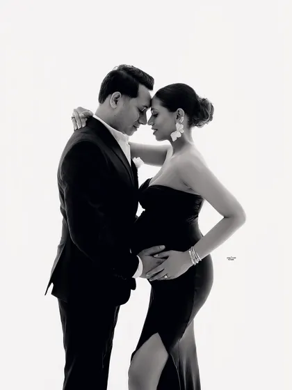 A beautiful, intimate black and white moment. This close-up shot focuses on the tender connection as they anticipate their baby's arrival.