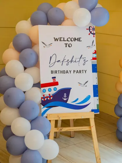 A welcome board for a nautical boat-themed birthday party.