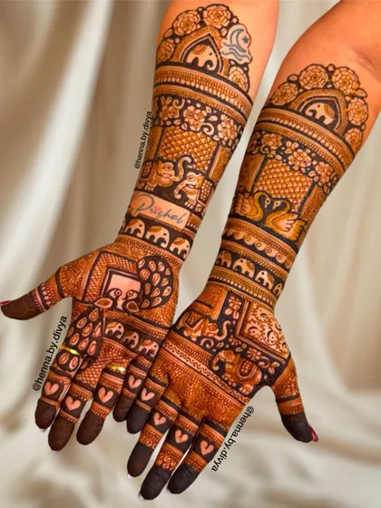 This elaborate bridal design is filled with auspicious elephant motifs. The patterns cover the hands and arms completely, creating a stunning and traditional statement.